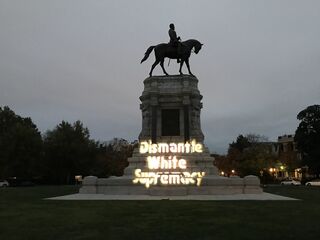  "Maryland Solidarity Brigade Projection - Dismantle White Supremacy on General Lee Statue in Richmond VA (Photos courtesy of Richmond DSA)" by Backbone Campaign/Licensed under CC BY 2.0