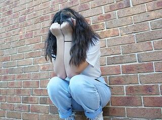  Depressed_girl_by_brick_wall by U314168 CC share alike 4.0