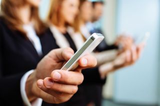 People looking at their cell phones during a meeting