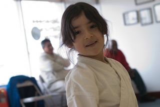 Hispanic girl dressed for Aikido class