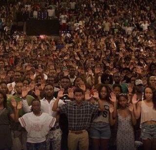 Howard University Students raising hands in 