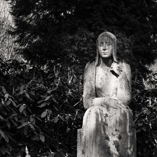 Statue of sad looking woman.