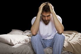 Worried and upset man in bed.