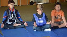 Meditating in lotus pose in public school yoga program