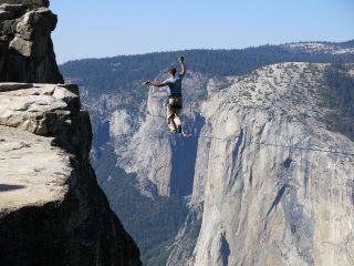 Man highlining at Taft Point in Yosemite National Park with El Capitan in the background.