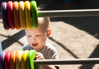 Purchased from Deposit Photos/Adorable boy playing Colorful Abacus 