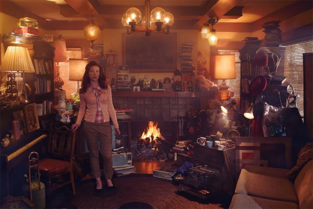 Woman standing in a cluttered living room