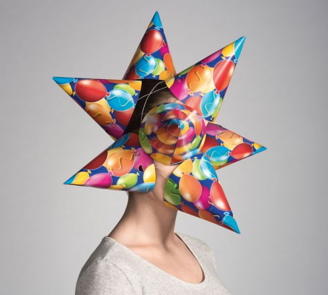 Woman with cone party hats covering her face and head