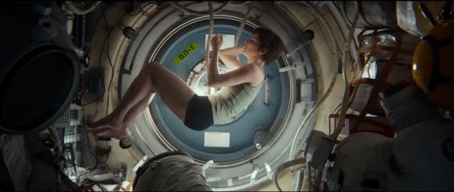 Sandra Bullock curled up in fetal position, in film Gravity, Soyuz spacecraft 