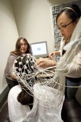 Inna Fishman and Rowena Ng place electrodes on the scalp of an individual with Williams syndrome.