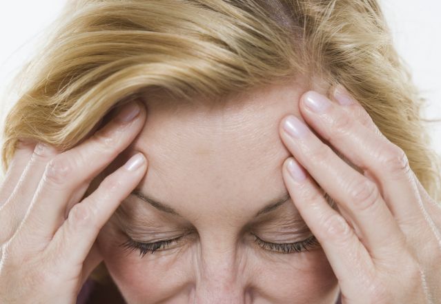 Grieving and Burned Out woman with headache