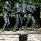 A flood disaster memorial in Fort Collins, Colorado depicting roles for men and women.